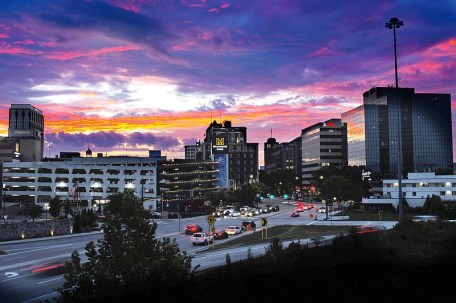 Staff photo by Robin Rudd / Dawn breaks over the Chattanooga skyline Sept. 6 as traffic moves on M.L. King Boulevard, through the West Village. An online site that tracks technology trends ranked Chattanooga as the No. 2 city in the nation for remote work.