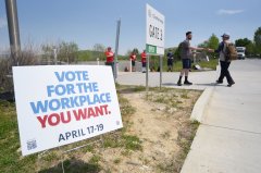 Staff photo by Matt Hamilton/ Union supporters hand out pamphlets to workers April 16 as they arrive in the parking lot at the Volkswagen Chattanooga plant.