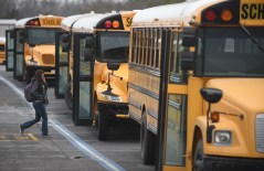 Staff File Photo / Students board buses at Catoosa County Schools, where a tax increase is in the offing.