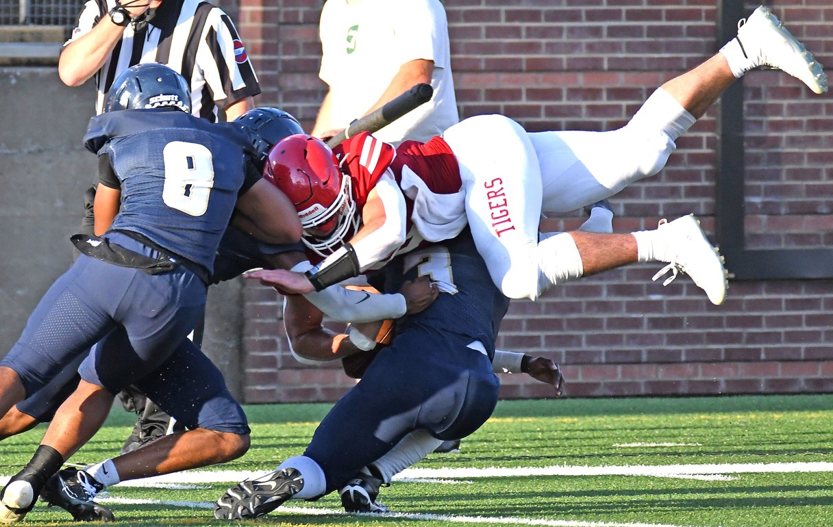 Staff photo by Robin Rudd / Whitwell's Brandon Easterly, right, is tackled by Chattanooga Prep's Cedric Bauilding (8) and Chevy Armour during a preseason jamboree matchup on Aug. 17 at Finley Stadium. Both teams boast tough defenses this year, with Whitwell's having not allowed a point and Chatt Prep on a streak of three straight shutouts.