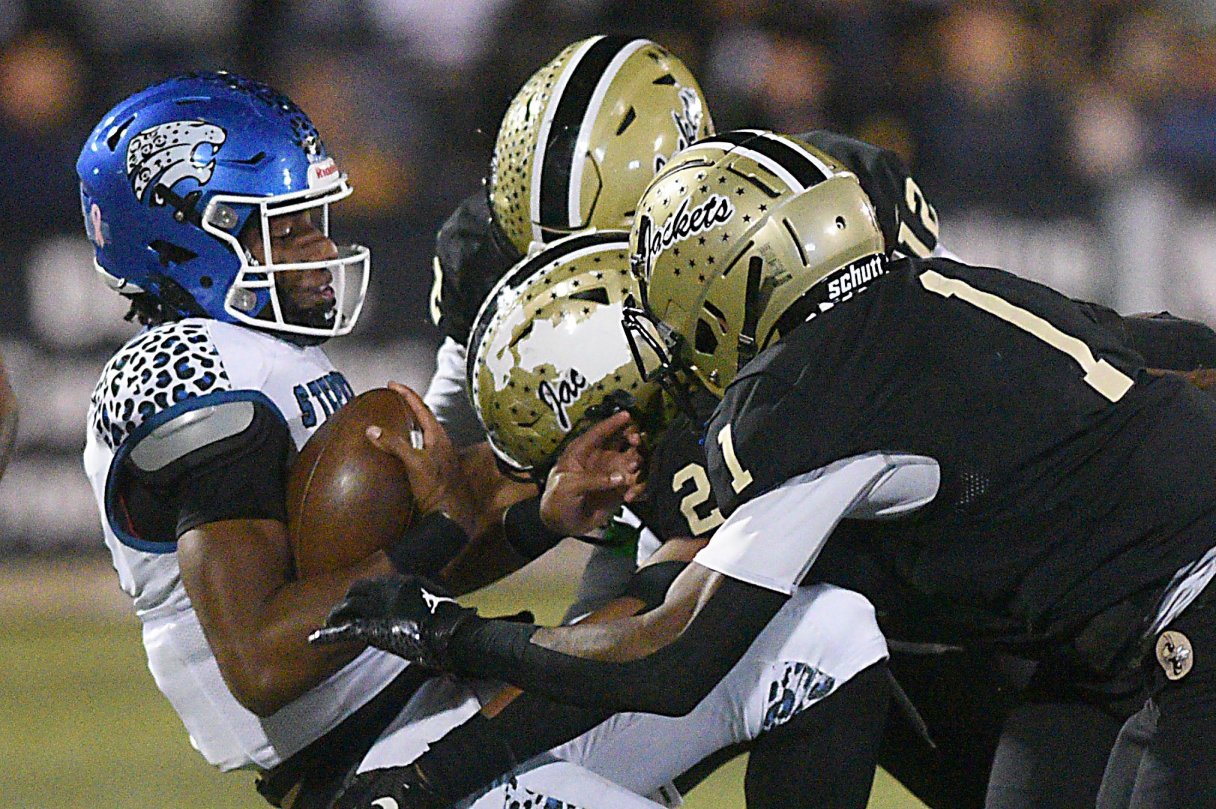Staff file photo by Matt Hamilton/ Calhoun defenders Clayton Goad, Blake Hammett and Kam Penny combine to stop Stephenson's Marte Barton in the Yellow Jackets' semifinal win Dec. 6. Calhoun faces Jefferson Wednesday in the GHSA Class AAA championship game.