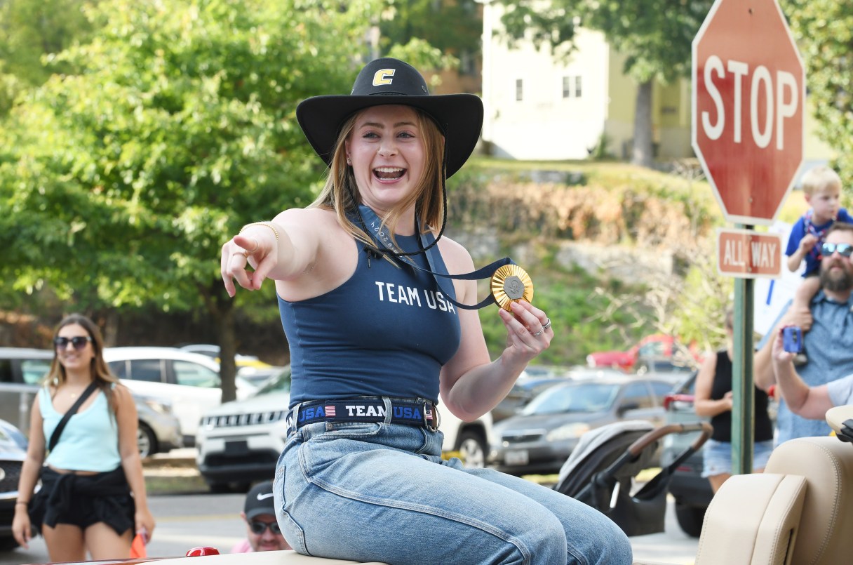Staff photo by Abby White / Weightlifter Olivia Reeves, of Hixson, points to a relative during the parade celebrating her Olympic win on Sept. 3, 2024.