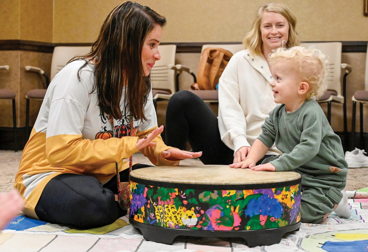 Staff photo by Abby White / Brooke Safford and Talon Driggers play the drum during a drum lesson. Safford leads music classes for toddlers to teach children the basics of music.