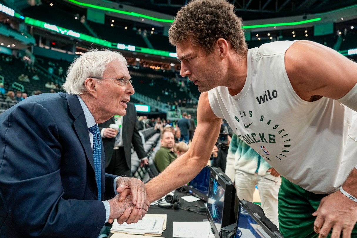 AP photo by Andy Manis / Milwaukee Bucks center Brook Lopez, right, shakes hands with broadcaster Hubie Brown on Sunday before the team's home game against the Philadelphia 76ers.