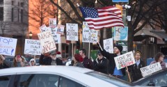 Staff photo by Matt Hamilton/ Protesters wave signs and chant during a Democratic rally at Miller Park on Monday, Feb. 17, 2025.