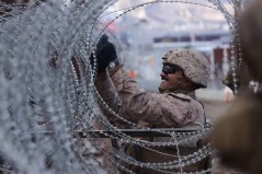 A still image from video published by the Defense Department on Jan. 27, 2025, showing U.S. Marines securing the border wall with concertina wire. The government is releasing photos and videos to promote President Donald Trump’s immigration agenda, including footage of troops at the border and close-up shots of shackled immigrants. (Department of Defense via The New York Times) — NO SALES; EDITORIAL USE ONLY —