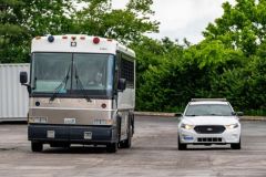 A detention bus is parked alongside a Metro Nashville Police Department cruiser on the parking lot at the ICE field office last week. (Martin B. Cherry / Nashville Banner)