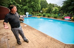 Staff photo by Matt Hamilton / Brian Smith at home by his pool, which he rents out using Swimply