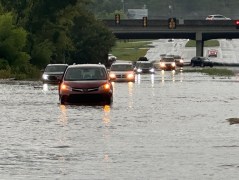Chattanooga Fire Department / Cars drive on a flooded road in Chattanooga on Aug. 12, 2025.
