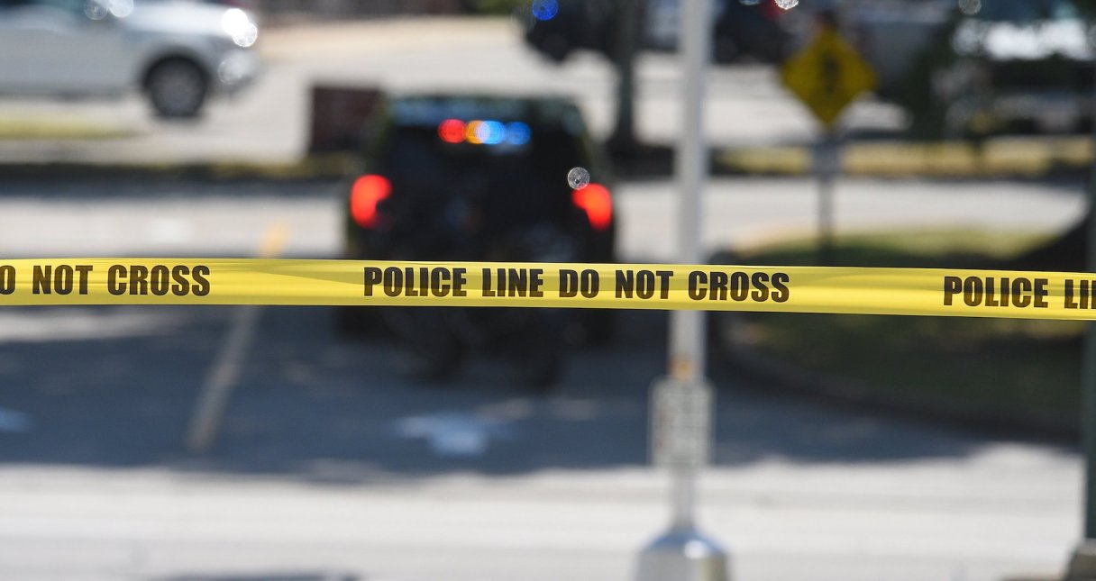 Staff photo by Matt Hamilton / Police tape flutters in the breeze in the parking lot at Hamilton Place mall June 24, 2024. The Tennessee Office of Criminal Justice Programs, which allocates federal funding in Tennessee for crime victims, has eliminated grants to agencies providing legal services to immigrants.
