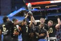 Staff photo by Matt Hamilton/ Calhoun players hold the state championship trophy after defeating Jefferson at Mercedes Benz Stadium in Atlanta on Wednesday, December 18, 2024.