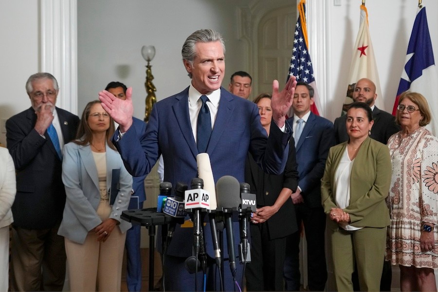 Accompanied by California and Texas lawmakers, California Gov. Gavin Newsom, center, discusses the push to schedule a special election to redraw California's Congressional voting districts, during a news conference in Sacramento, Calif., Friday Aug. 8, 2025. (AP Photo/Rich Pedroncelli)