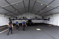 A group of Southern Company employees views Archer s Midnight electric vertical take-off and landing (eVTOL) aircraft at DeKalb-Peachtree Airport in Atlanta. Archer Aviation is one of many Georgia based aerospace industry firms. (Arvin Temkar/AJC 2024)