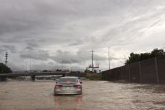 Staff photo by Alison Gerber / A car drives through a stretch of Interstate 24 between South Moore and McBrien roads that is flooded in all lanes on Aug. 12, 2025.