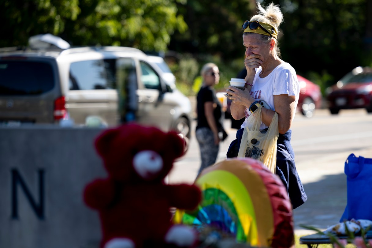 Kimberly Mason, a local art teacher who lives in the neighborhood, reacts at a memorial outside Annunciation Catholic Church after Wednesday's shooting, Sunday, Aug. 31, 2025, in Minneapolis. (AP Photo/Ellen Schmidt)