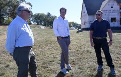 Staff photo by Abby White / John “Thunder” Thornton, left Dane Bradshaw, and Josh Cain speak during an interview. John “Thunder” Thornton and his colleagues gave a tour of his new Riverton Farms development in Chattanooga on Wednesday, October 15, 2025.