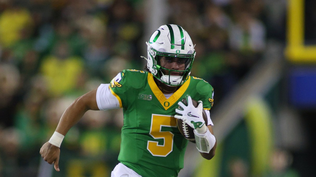 Oregon quarterback Dante Moore (5) runs the ball during the first half of an NCAA college football game against Minnesota Friday, Nov. 14, 2025, in Eugene, Ore. (AP Photo/Lydia Ely)