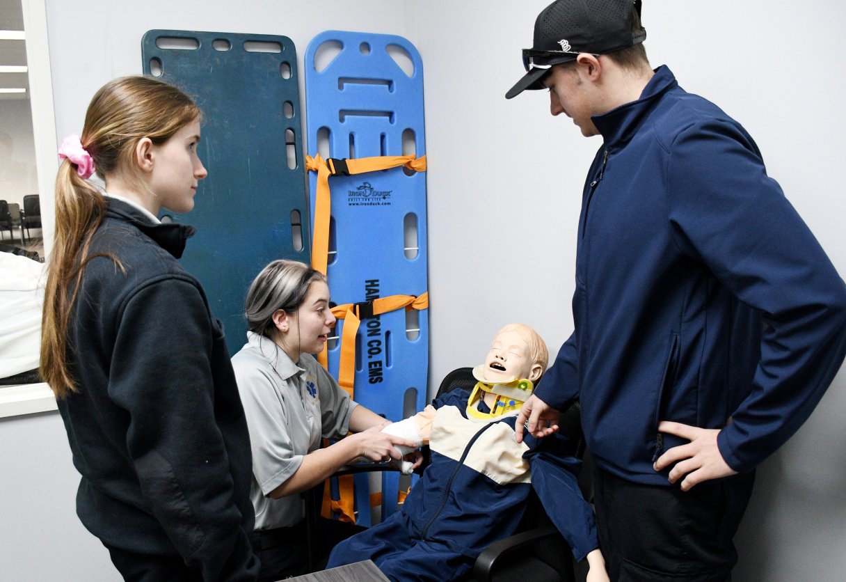 Staff File Photo By Robin Rudd / Student Abigail Christensen wraps a pediatric mannequin's arm during a wound dressing exercise as Maggie Nunley and Bradley Dowlen observe as part of Hixson High School's health care and medical careers Future Ready Institute at Hamilton County's EMS Training Center earlier this year.