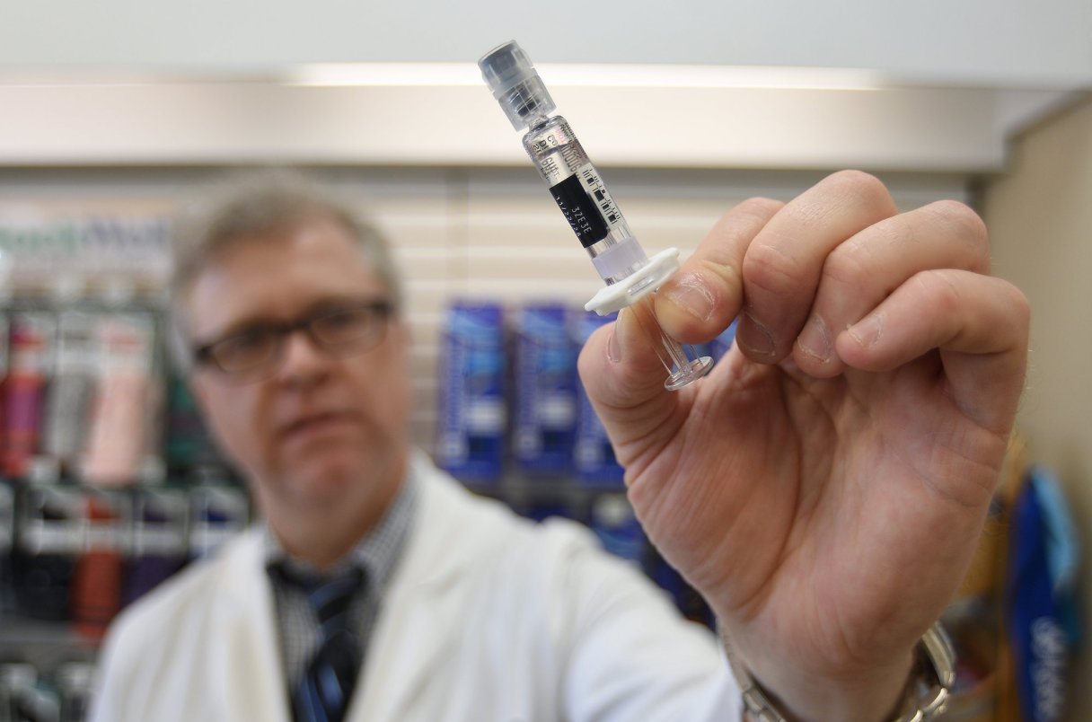 Staff file photo by Matt Hamilton / Pharmacist Phil Smith holds a dose of the measles vaccine at Access Family Pharmacy. Nearly 90% of Georgia parents believe childhood vaccines are safe, according to a recent survey.