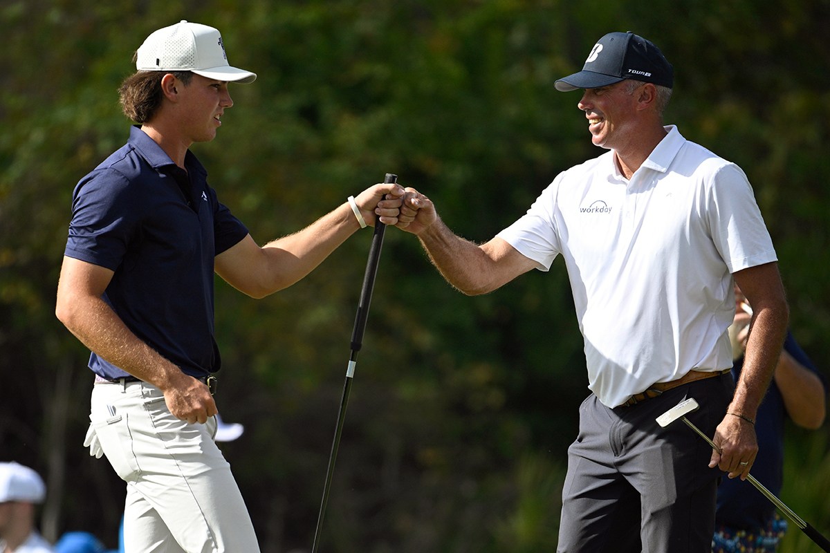 AP photo by Phelan M. Ebenhack / PGA Tour player Matt Kuchar, right, gets a fist bump from his son Cameron after sinking an eagle putt on the third green at the Ritz-Carlton Golf Club during the final round of the PNC Championship on Sunday in Orlando, Fla.