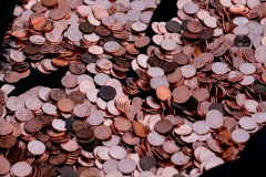 Pennies lay in a casket during a mock funeral for the penny, which was discontinued earlier this year, in front of the Lincoln Memorial in Washington. As pennies vanish from the American landscape, states are beginning to weigh in on how retailers should respond. (AP Photo/Julia Demaree Nikhinson)