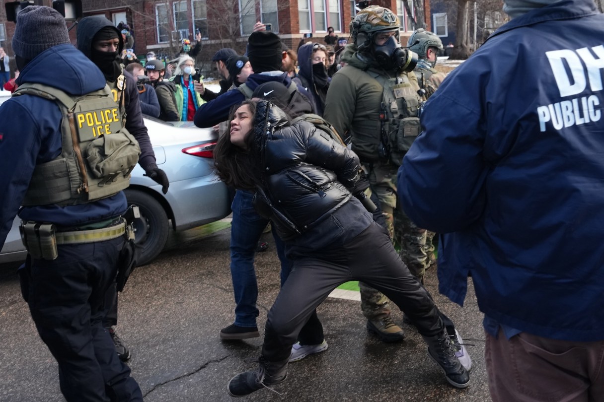 AP Photo by Adam Gray / Aliya Rahman is detained by federal agents near the scene where Renee Good was fatally shot by an ICE officer last week, Tuesday, Jan. 13, 2026, in Minneapolis.