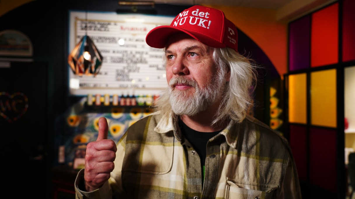 Store owner Jesper Rabe Tonnesen gives a thumbs up as he wears a red cap for sale that he created with the slogan "Nu det NUUK!," a twist on the Danish phrase “Nu det nok,” meaning “Now it’s enough,” substituting Nuuk, Greenland’s tiny capital, in Copenhagen, Denmark, Thursday, Jan. 15, 2026. (AP Photo/James Brooks)