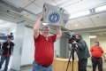 Staff Photo by Seth Carpenter/ Bargaining representative Chris Brown carries out a ballot box following a vote by Volkswagen employees at the Chattanooga plant to approve a contract between the United Automobile Workers of America union and VW.