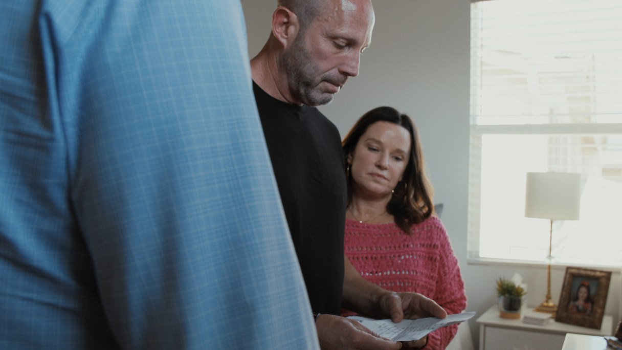 Photo by Netflix via TNS / Parents Bryan and Cindy Muehlberger read notes their daughter Gracie wrote to her future self in "All the Empty Rooms."