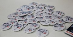 Staff photo by Larry Sullivan II / A pile of Shawn Harris buttons sits on a table. Harris leads all contenders, regardless of party, in cash raised during Georgia's 14th Congressional District special election campaign.