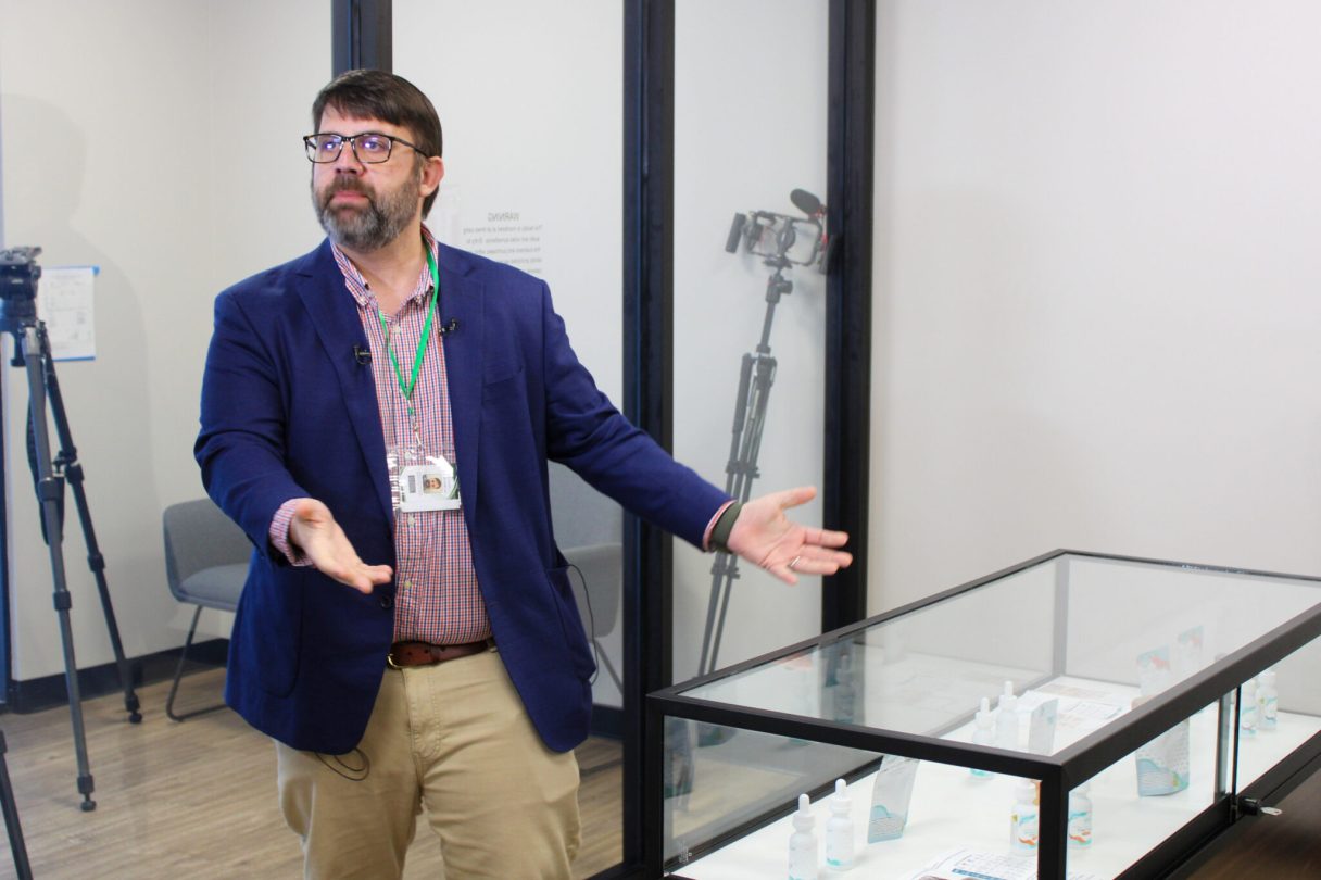 Vince Schilleci, owner of Callie's Apothecary, gestures to a display case that has mock medical cannabis products during a tour on May 16, 2026, in Montgomery, Ala. Schilleci said the dispensary is days away from opening to patients. (Anna Barrett/Alabama Reflector)