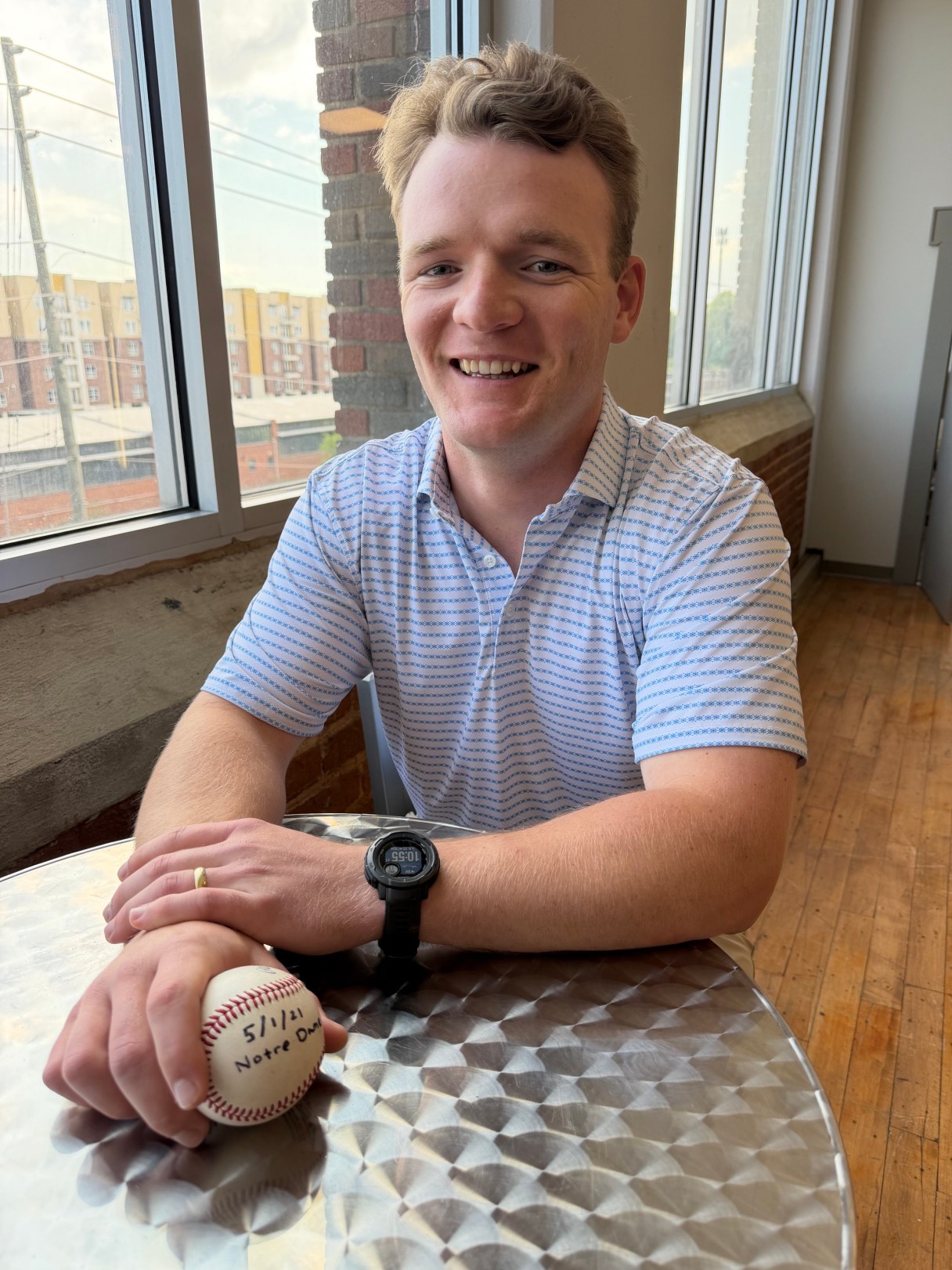 Staff photo by Mark Kennedy / Max Riemer, 26, of Chattanooga, shows off a home run ball he hit five years ago while in college. Riemer says the ball was returned to him by a young man who was touring the University of Notre Dame in May 2001.