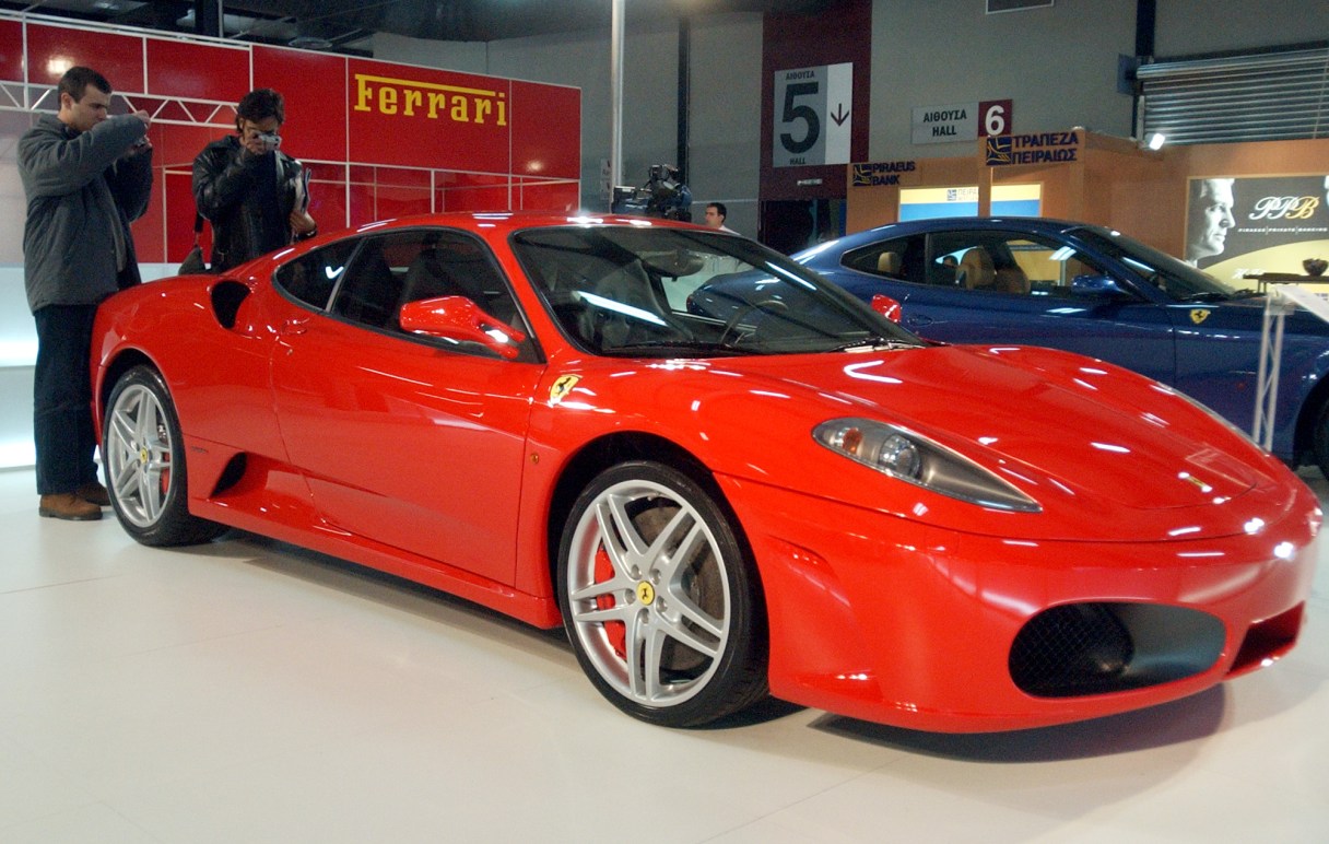 Visitors take photographs of the Ferrari F430 during an executive cars exhibition in Athens, Wednesday, Nov. 24, 2004.(AP Photo/Thanassis Stavrakis)