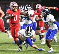 Staff Photo by Robin Rudd / Baylor's David Gabriel Georges (0) fights off McCallie defenders during a big run.. The Baylor Red Raiders hosted the McCallie Blue Tornado in the semifinals of the TSSAA Division II Class AAA football playoffs on Nov. 21, 2025.