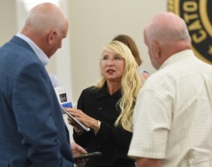 Staff photo by Matt Hamilton / Paula Muina talks with Commissioners Chuck Harris, right, and Richard Tharpe after a Catoosa County Commission meeting July 7, 2026.