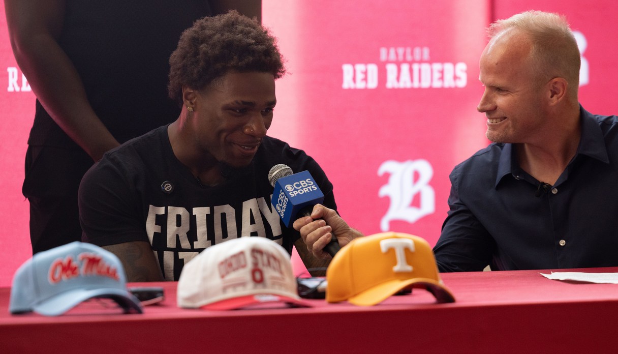 Staff photo by Larry Sullivan II/David Gabriel Georges, left, speaks to a CBS Sports correspondent at his commitment ceremony at the Baylor Probasco Academic Center on July 22, 2026.