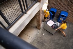 Staff Photo by Seth Carpenter / Charlie Morton and Elizabeth Springer push a freshman's belongings to a dorm at Boling Apartments during Operation Move-In at UTC on Wednesday, Aug. 19, 2026.