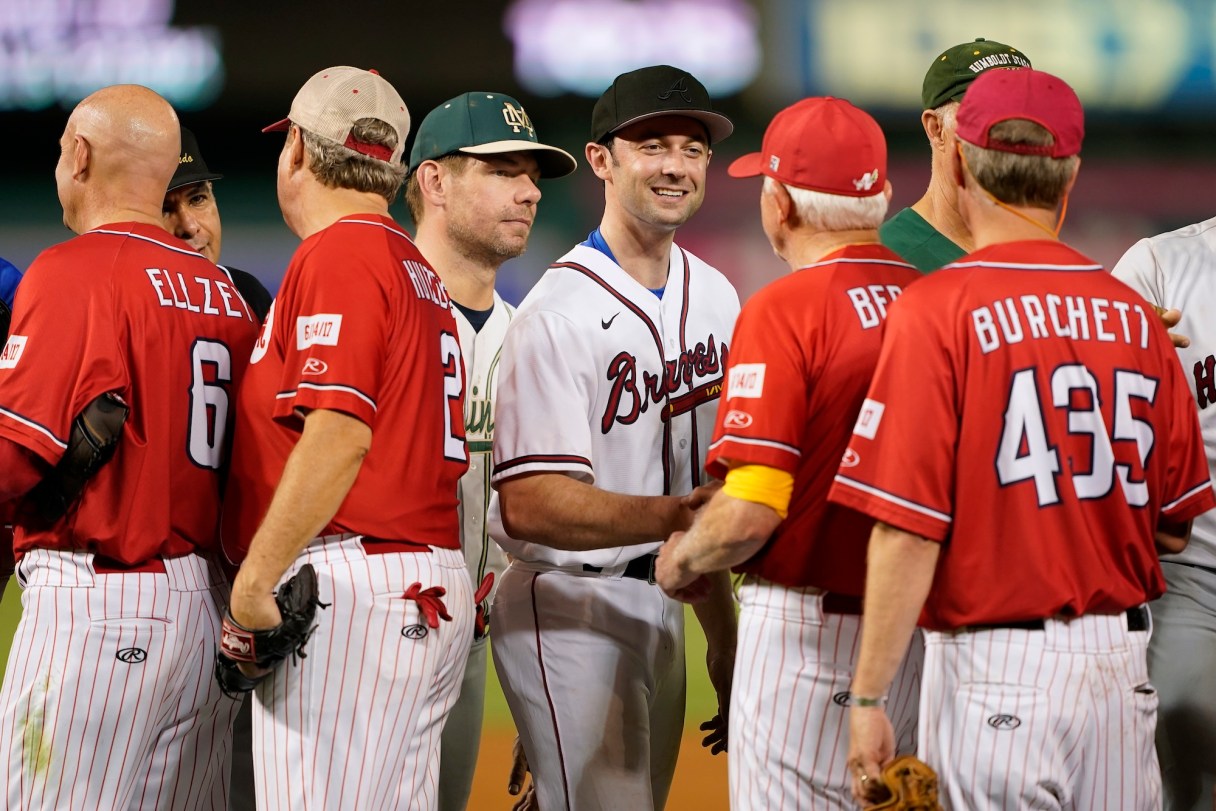 AP Photo by Patrick Semansky / Sen. Jon Ossoff, D-Ga., center, and Rep. Eric Swalwell, D-Calif., left, speak with members of the Congressional Republican baseball team after the Congressional baseball game, Thursday, July 28, 2022, in Washington. The Republicans won 10-0. The annual baseball game between Congressional Republicans and Democrats raises money for charity.