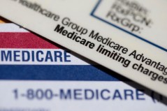 AP File Photo By Jenny Kane / A Medicare Advantage PPO card rests on top of a Medicare card in Portland, Ore., in 2024.