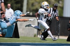 UTC photo by William Glassgow / UTC's Davon Kiser keeps the ball tucked in tight as he finishes off a 56-yard punt return for a touchdown in the Mocs' 27-8 win over The Citadel on Saturday in Charleston, S.C.