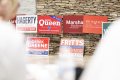 Staff Photo By Seth Carpenter / Various campaign signs for Republican candidates stand against a wall during a Republican rally at Chester Frost Park in June.