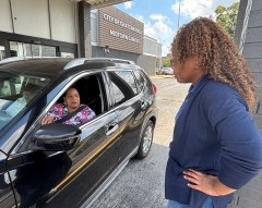 Statt photo by John P. Boan / Taneka Albert with the Chattanooga Office of Family Empowerment, right, speaks to resident Valencia Dubose during the city's Low Income Home Energy Assistance Program drive-through event Oct. 2, 2026. Those interested in applying to the program can do so through the city's website.