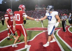 Staff Photo by Matt Hamilton / Baylor quarterback Keegan Croucher (10) and McCallie offensive lineman Titus Tervanen (57) shake hands as team captains meet at midfield in Heywood Stadium before the start of Friday night's TSSAA Division II-AAA East Region football rivalry game in Chattanooga.