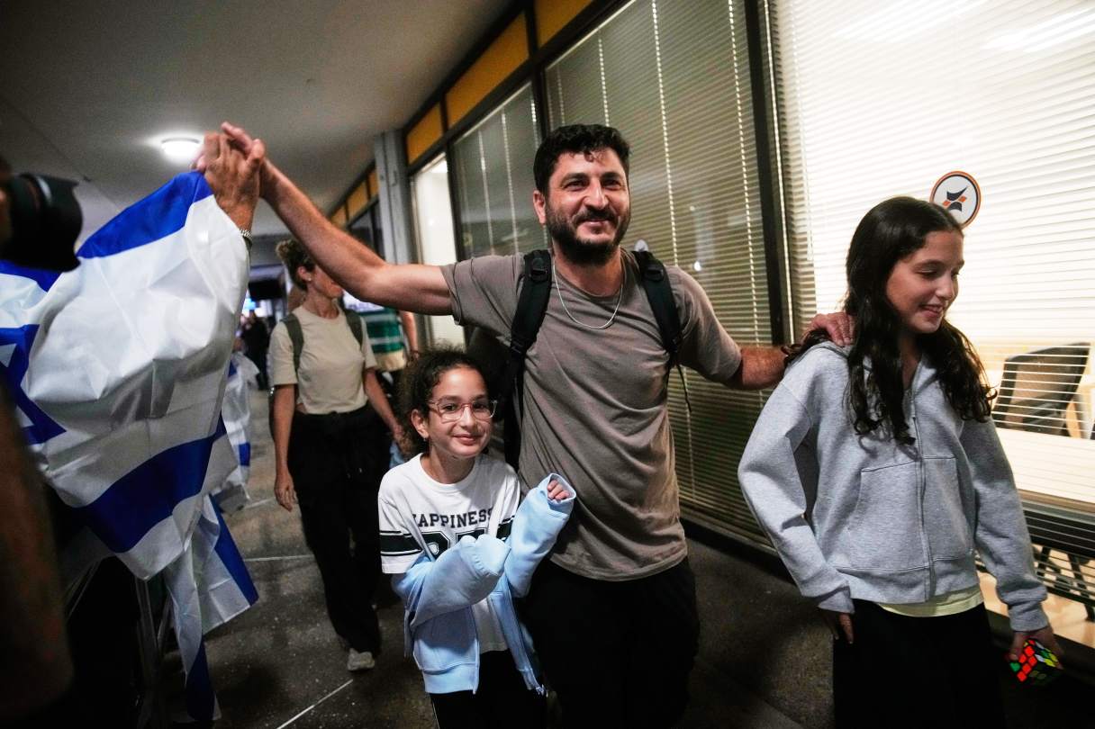 AP Photo/Ohad Zwigenberg / Israeli passengers who had been aboard a FlyDubai aircraft that made an emergency landing in Saudi Arabia are welcomed at the arrivals gate at Ben Gurion International Airport near Tel Aviv, Israel, late last month.