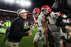 University of Georgia photo / Georgia football coach Kirby Smart celebrates Saturday night's 20-17 victory over Alabama in Tuscaloosa with tight end Lawson Luckie (7) and left tackle Earnest Greene III (71).
