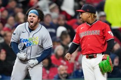 The Tampa Bay Rays' Jonathan Aranda, left, celebrates after an RBI single as Cleveland Guardians third baseman José Ramírez looks on during the seventh inning of Game 4 of the AL Championship Series on Saturday. (AP Photo/David J. Phillip)