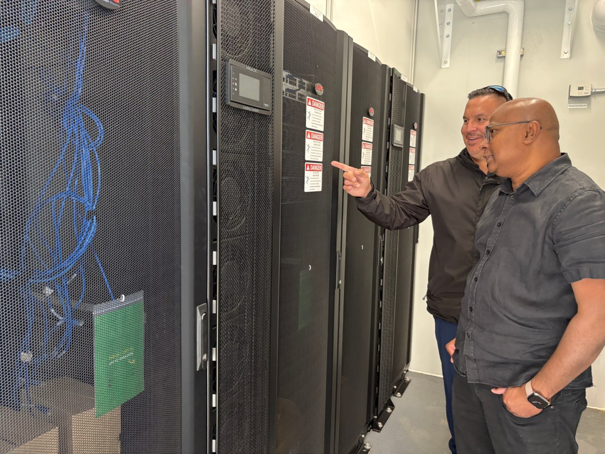 Wiikwemkoong's Chief Technology Officer Michael McCormick, right, and a worker inspect the community's data center in Wiikwemkoong, Ontario, Canada, July 22, 2026. (AP Photo/Kelvin Chan)
