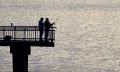 Staff file photo / Sometimes the best things in life are the simple things, such as fishing along the Tennessee River at Riverfront Parkway, as this couple did in 2024.