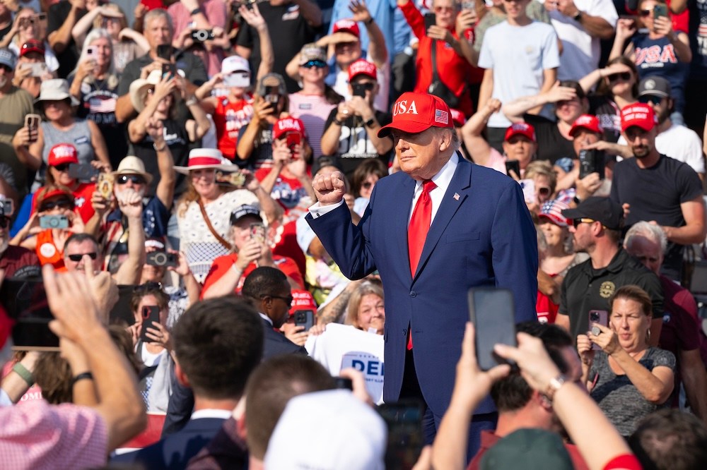 Staff Photo by Seth Carpenter/ President Donald Trump works the crowd as he arrives at a rally for himself at Dalton Municipal Airport on Friday, Oct. 16, 2026.